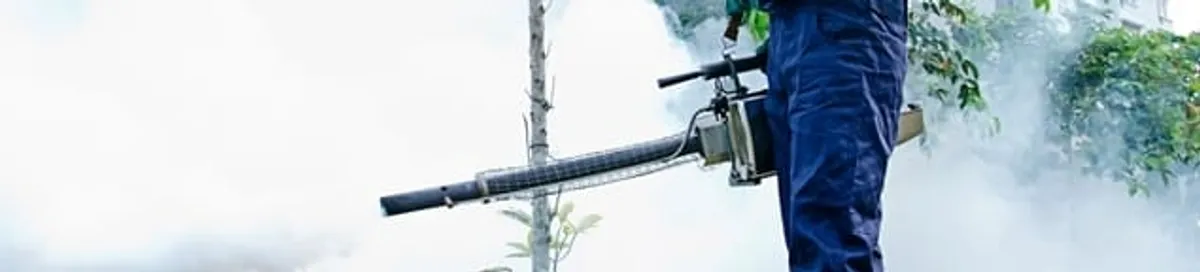 Pest control technician fogging an outdoor area for insect control in Orange, CA