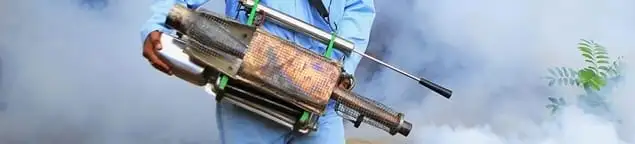Fumigation technician using a fogger for deep pest treatment in Orange, CA